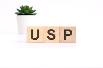 USP - unique selling proposition - acronym on wooden cubes on white background. business concept