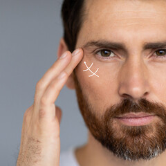 Close up portrait of middle aged bearded man, wanting to lift face to remove wrinkles and skin...