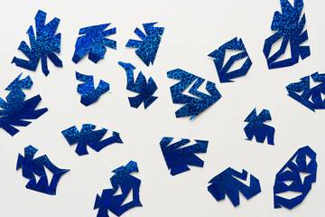 abstract cut paper shapes on white