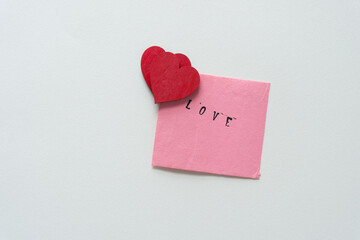 wooden hearts and pink note with the word love 