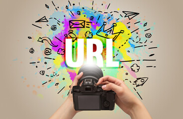 Close-up of a hand holding digital camera with abstract drawing