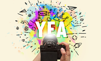 Close-up of a hand holding digital camera with abstract drawing