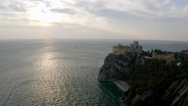 aerial drone shot of duino castle near trieste italy in sunset
