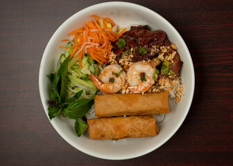 Pho soup with egg rolls, shrimp and beef