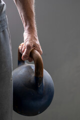 Person getting fit using kettlebell weights
