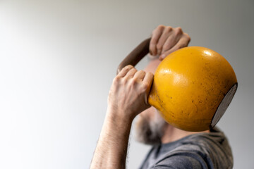 Person getting fit using kettlebell weights