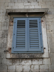 Fototapeta na wymiar old window on the wall of old house