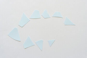 cut paper shapes on blank paper