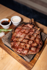 Ribeye steak with bone in on wooden board