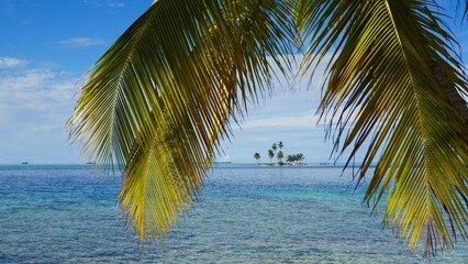 An uninhabited Robinson Crusoe-like islet as seen from the Pelicano Island in the San Blas archipelago, Panama. 