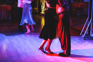Couples dancing traditional latin argentinian dance milonga in the ballroom on a festival, tango...
