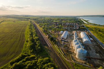 Aerial view of industrial ventilated silos for long term storage of grain and oilseed. Metal...