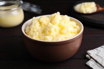 Bowl of Ghee butter on wooden table, closeup