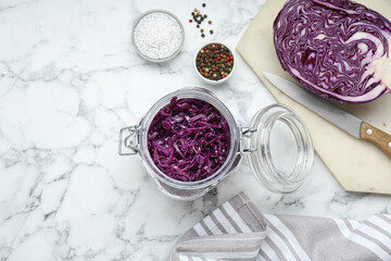 Tasty red cabbage sauerkraut and different ingredients on white marble table, flat lay. Space for...