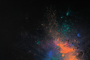 Colorful powder dyes on dark background, top view with space for text. Holi festival