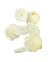 Whole and cut onion bulbs falling on white background