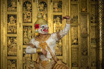Fototapeta na wymiar Khon Hanuman is traditional dance drama art of Thai classical monkey masked from the Ramayana with a backdrop of Thai paintings in a public place at Wat Phra Khao, Ayutthaya province, Thailand