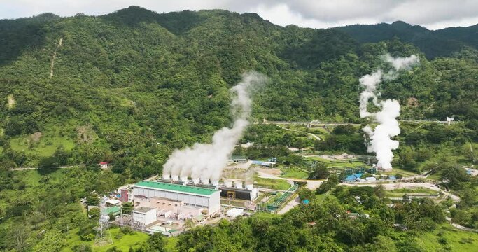 Aerial view of geothermal power production plant. Geothermal station with steam and pipes. Negros, Philippines.