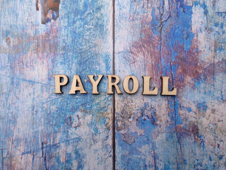 Wooden letters arranged with the word PAYROLL