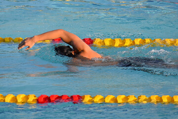 Sport man swimming in the pool at the sport complex.Professional Athlete Training for the Championship.Male Swimmer swimming in swimming pool.