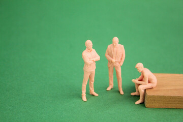 three miniature people are discussing. Business strategy concept. important discussion