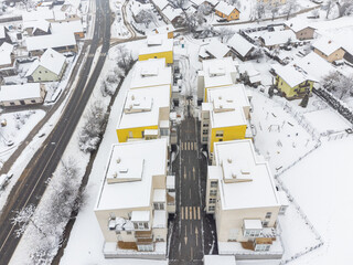 New apartment buildings in winter. Covered in snow. Drone aerial view