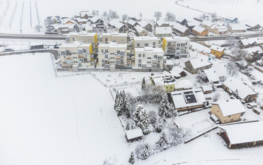 New apartment buildings in winter. Covered in snow. Drone side view