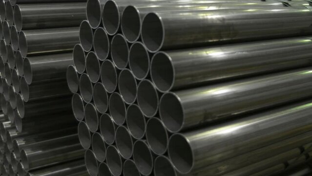 Stainless steel pipes in a warehouse of plant on production of metal pipes of a profile