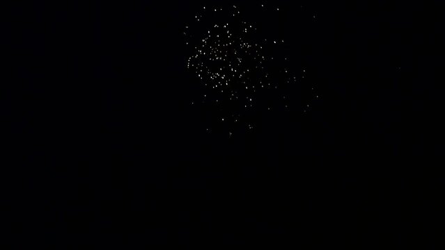 Explosion of bright colorful part of fireworks on black background to create a set salute on video for holiday new year, birthday, wedding or other celebration.
