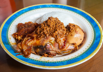 Nasi Gudeg. Traditional Javanese meal of young jack fruit stew accompanied with spicy cattle skin cracker stew and chicken curry.