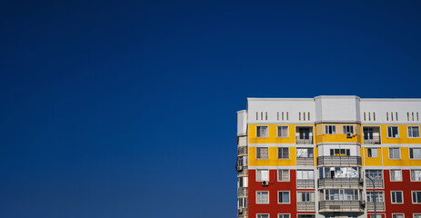 residential new house with windows and balconies on a blue sky background