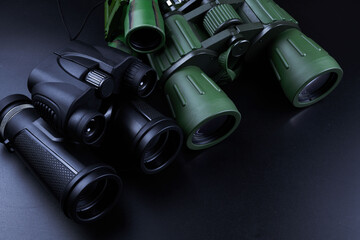 New binoculars isolated on black background. Flat lay, top view