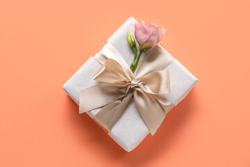 Beautiful gift box with eustoma flower on color background