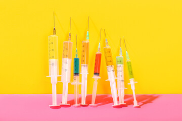 Medical syringes with remedy on color background