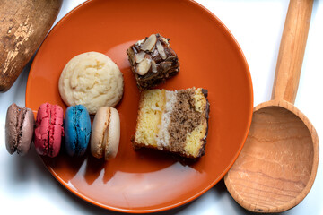 Shallow Depth of Field image of three cookies served in a wooden spoon on a wooden board.