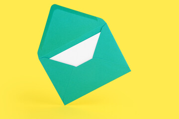 Paper envelope with card on yellow background