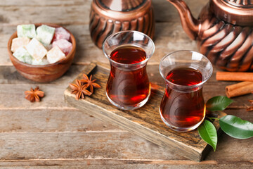 Board with cups of Turkish tea on wooden background