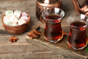 Board with cups of Turkish tea on wooden background, closeup