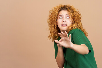 Woman gesturing with her hands in fear