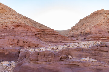 Fantastically beautiful landscape in the national nature reserve - Red Canyon in the rays of the setting sun, near the city of Eilat, in southern Israel