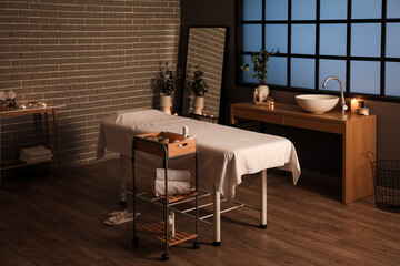 Interior of spa salon with couch, tables and mirror
