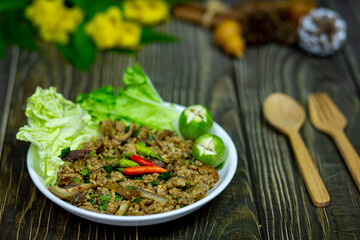 Thai esan food, spicy minced boar salad with fresh vegetables served on the dining table It's my lunch for today.