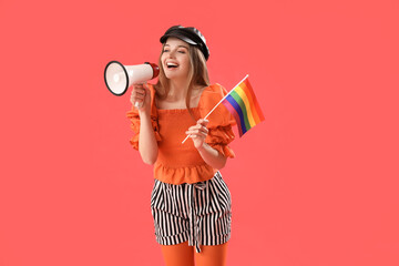 Beautiful young woman with LGBT flag shouting into megaphone on red background