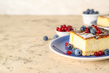 Plate with piece of cottage cheese casserole and berries on light background