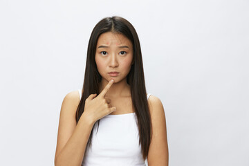 Fototapeta premium Asian woman facial skin problems, acne and inflammation, red rashes and allergies, chicken pox, sadness from rashes. Facial skin care concept for diseases and nerves