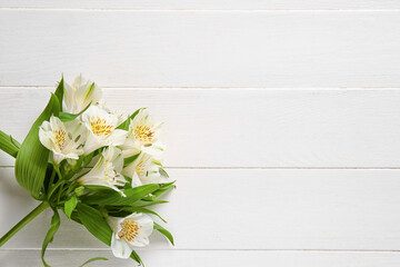 Bunch of beautiful alstroemeria flowers on light wooden background