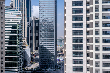 modern building. Reflective skyscrapers, business office buildings. Facade of modern office building. Doha business district. Business, economy and finances concept.