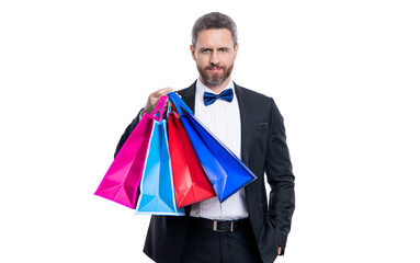 positive tuxedo man with shopping bag isolated on white background. tuxedo man after shopping.