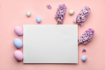 Composition with blank card, Easter eggs and hyacinth flowers on pink background