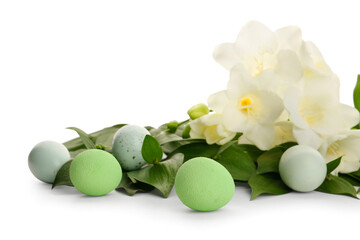 Composition with beautiful freesia flowers, plant branches and Easter eggs on white background, closeup